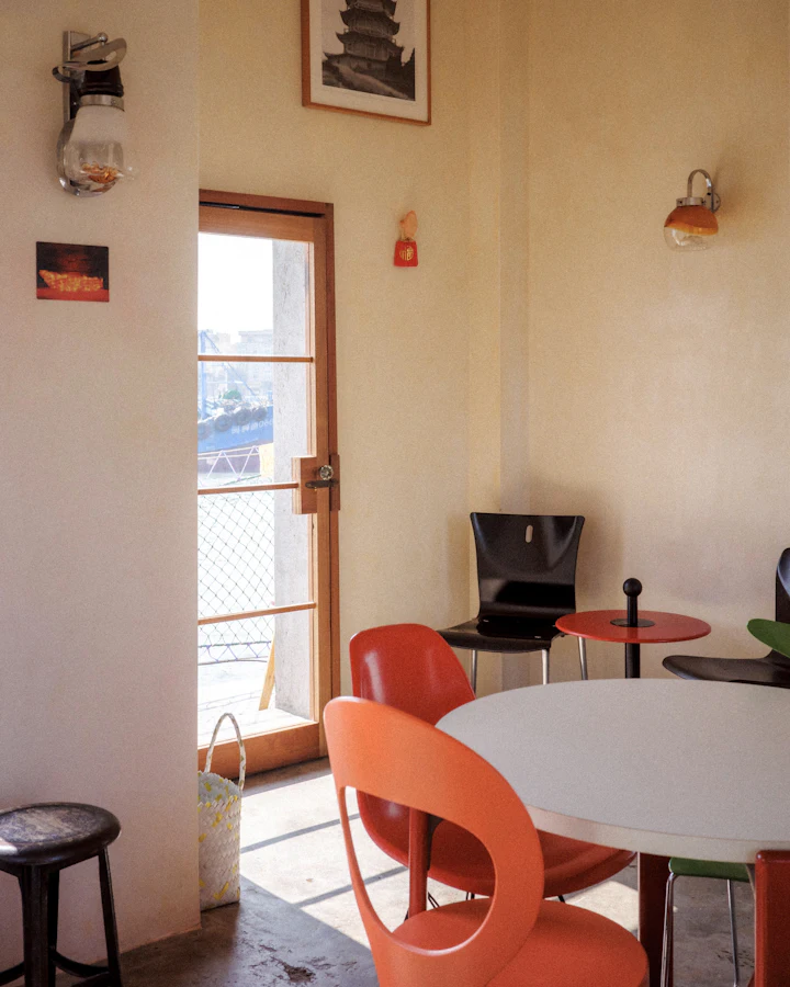 Sunny corner with orange chairs and a round white table